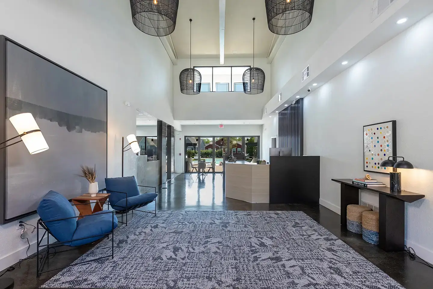 Entrance hall with front desk, casual seating, and ambient lighting.